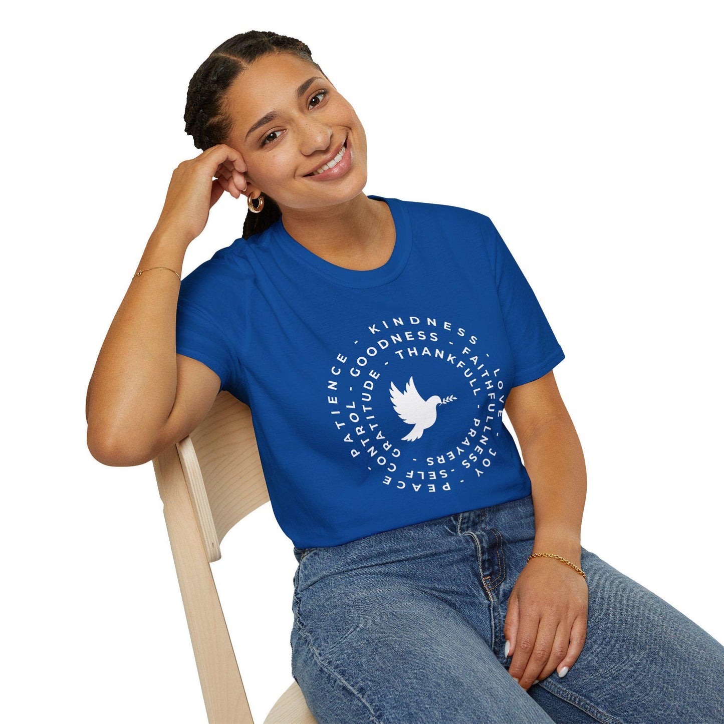 Woman wearing a blue t-shirt with a white dove and text design, sitting on a chair.